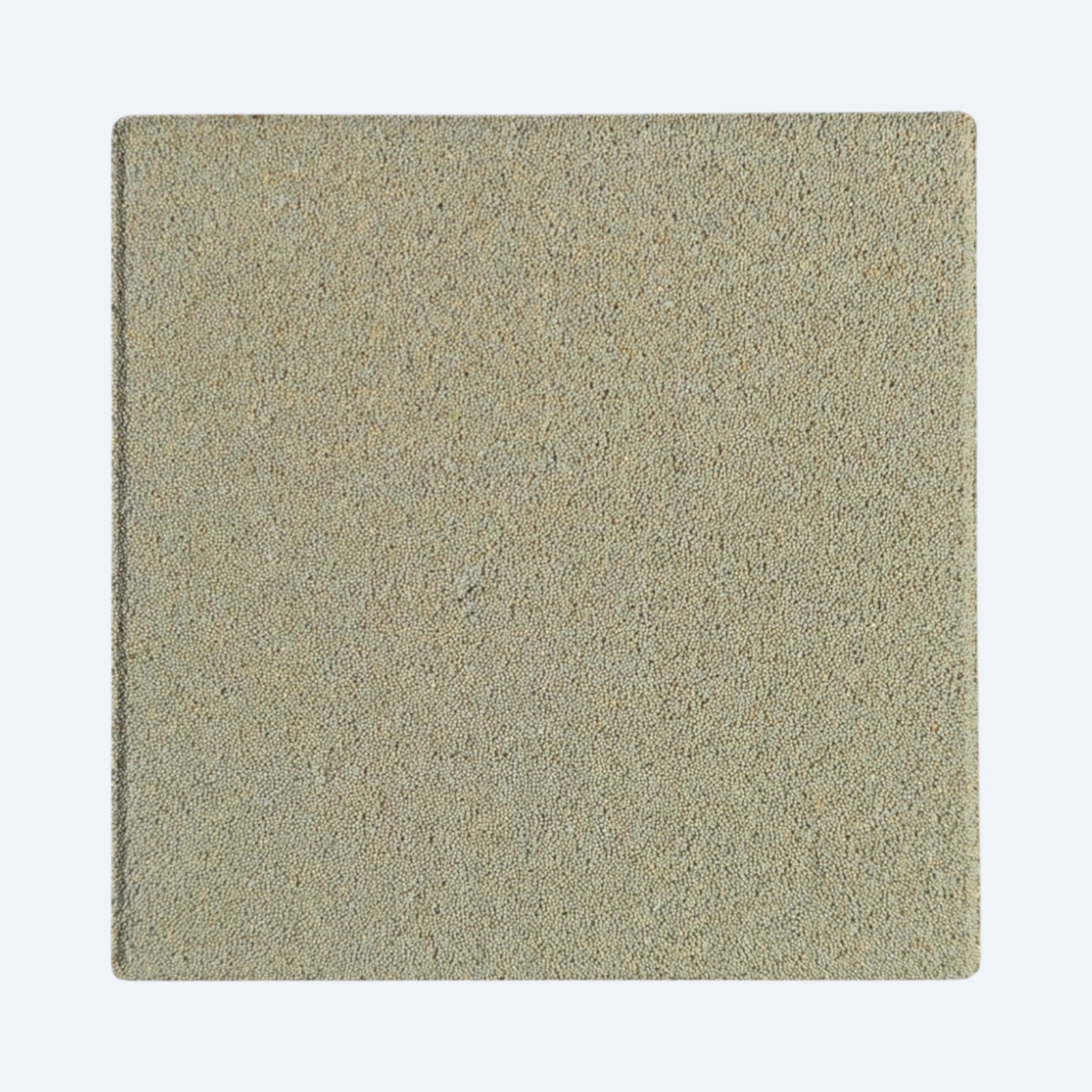 Square piece of textured ceramic on a white background